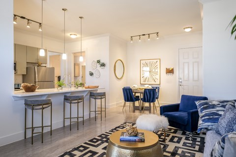 an open living room and kitchen with a dining room table and chairs